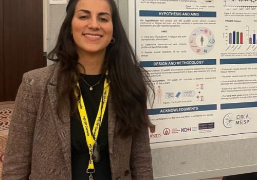 Doriana standing in front of her poster for the endMS meeting