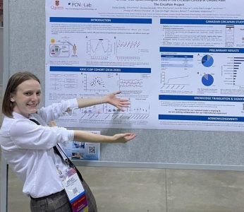 Hailey proudly shows off her poster at IASP, 2022