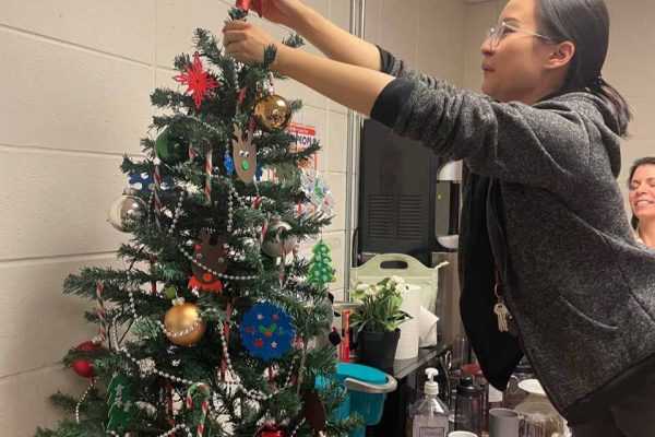 Vina putting on the tree topper