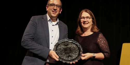 Dr. Ghasemlou is holding a plaque with Dean Jane Philpott